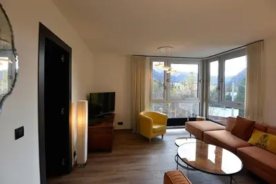 a living room with a couch and a tv at Quartz - Appt 4 etoiles vue Mont-Blanc - Centre in Chamonix-Mont-Blanc