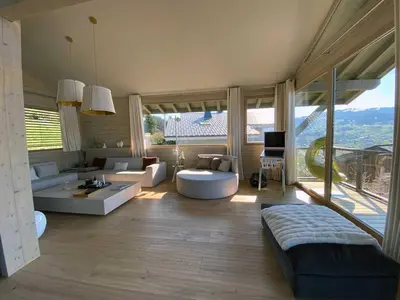 a living room with a couch and a table at JAMES TAMG31 - luxury design chalet Megeve in Combloux