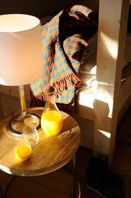 a table with two oranges on it next to a bed at JAMES TAMG31 - luxury design chalet Megeve in Combloux