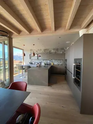 a kitchen with a table and a counter top at JAMES TAMG31 - luxury design chalet Megeve in Combloux