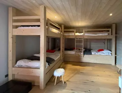 a room with three bunk beds and a stool at JAMES TAMG31 - luxury design chalet Megeve in Combloux