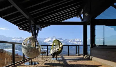 a view of the mountains from the balcony of a house at JAMES TAMG31 - luxury design chalet Megeve in Combloux