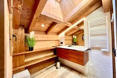 a log cabin bathroom with a sink and wooden ceilings at Cozy chalet in Combloux near the slopes in Combloux