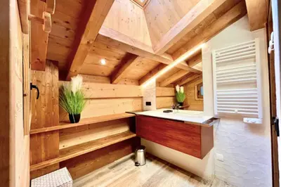 a bathroom in a log cabin with a sink at Cozy chalet in Combloux near the slopes in Combloux