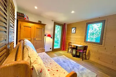a living room with a couch and a table at Cozy chalet in Combloux near the slopes in Combloux