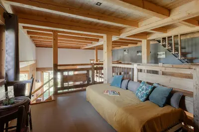 a bedroom with a large bed in a room with wooden ceilings at Appt Vincent - 200 m2 - Ideal famille - Vue Mont-B in Cordon