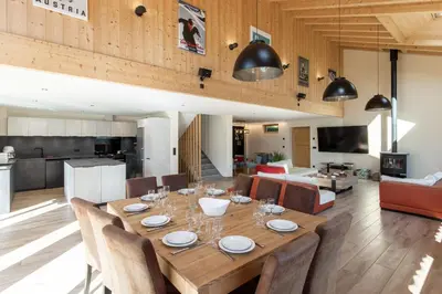 a dining room and living room with a table and chairs at Chalet La Source - Ideal familles ski et rando in Chamonix-Mont-Blanc