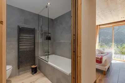 a bathroom with a bath tub and a toilet at Chalet La Source - Ideal familles ski et rando in Chamonix-Mont-Blanc