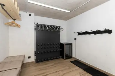 a room with a black wine rack on the wall at Chalet La Source - Ideal familles ski et rando in Chamonix-Mont-Blanc