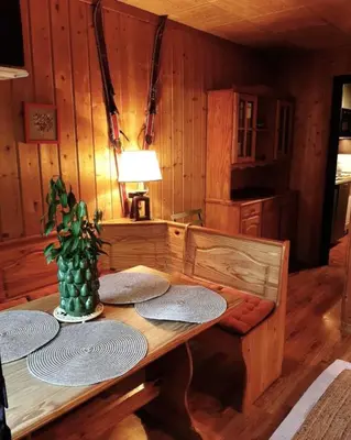 a wooden table with plates on it in a room at Le Roffie-lan in Les Contamines-Montjoie