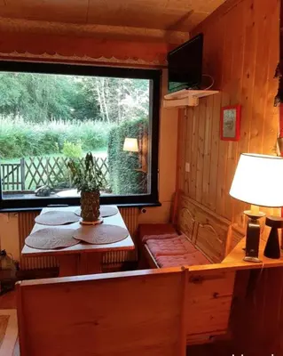 a room with a window and a table with a lamp at Le Roffie-lan in Les Contamines-Montjoie
