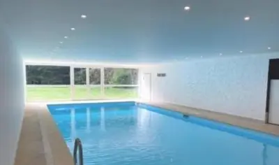 a large swimming pool with blue water at Le Roffie-lan in Les Contamines-Montjoie