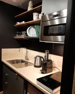 a kitchen with a sink and a microwave at Le Roffie-lan in Les Contamines-Montjoie