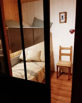 a room with two bunk beds and a chair at Le Roffie-lan in Les Contamines-Montjoie