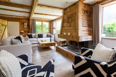 a living room with a fireplace in a house at Chalet Martinique - Chamonix All Year in Chamonix-Mont-Blanc