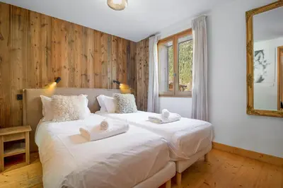two white beds in a room with a window at Chalet Scandinave - Ski-in out Piste Flegere - Next to Golf - By Cozee Rentals in Chamonix-Mont-Blanc