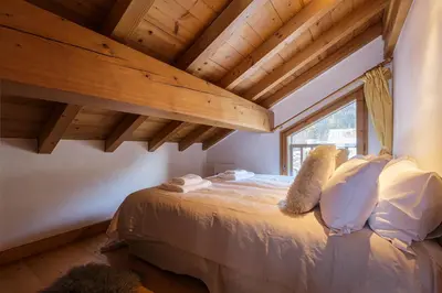 a bedroom with a bed with towels on it at Chalet Scandinave - Ski-in out Piste Flegere - Next to Golf - By Cozee Rentals in Chamonix-Mont-Blanc