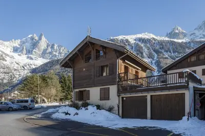 a house in the snow with a balcony at Chalet Scandinave - Ski-in out Piste Flegere - Next to Golf - By Cozee Rentals in Chamonix-Mont-Blanc