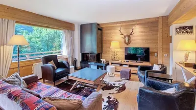 a living room with a couch and a table at 1 Sunshine - PROCHE CENTRE - in Megève