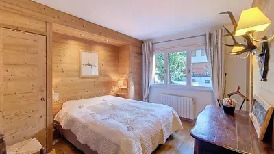 a bedroom with a bed and a window at 1 Sunshine - PROCHE CENTRE - in Megève