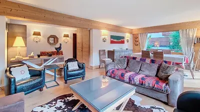 a living room with a couch and chairs and a table at 1 Sunshine - PROCHE CENTRE - in Megève