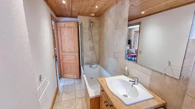 a bathroom with a sink and a bath tub at 1 Peupliers - CENTRE du VILLAGE - in Megève