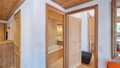 a room with wooden doors and a bathroom at 1 Peupliers - CENTRE du VILLAGE - in Megève