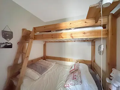 a bedroom with a bunk bed with a ladder at PE317 - 4 pieces 6 a 7 pers proximite centre in Les Carroz d'Araches