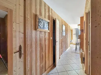 a hallway with wood paneled walls and a doorway at PE317 - 4 pieces 6 a 7 pers proximite centre in Les Carroz d'Araches