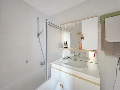 a white bathroom with a sink and a shower at PE317 - 4 pieces 6 a 7 pers proximite centre in Les Carroz d'Araches