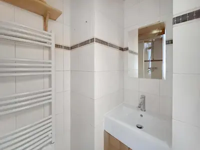 a white bathroom with a sink and a mirror at PE317 - 4 pieces 6 a 7 pers proximite centre in Les Carroz d'Araches