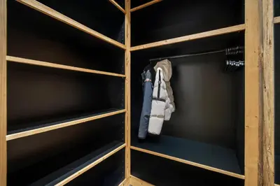 a closet with wooden shelves at Luxury Chalet Black Mountain - 4BR, Sleeps 10, Fireplace, Mountain Views & Garden - Megève in Megève