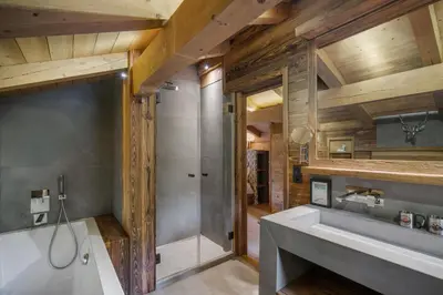 a bathroom with a tub and a sink and a shower at Luxury Chalet Black Mountain - 4BR, Sleeps 10, Fireplace, Mountain Views & Garden - Megève in Megève