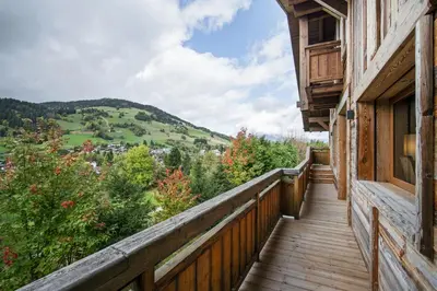 a wooden balcony with a view of a mountain at Luxury Chalet Black Mountain - 4BR, Sleeps 10, Fireplace, Mountain Views & Garden - Megève in Megève