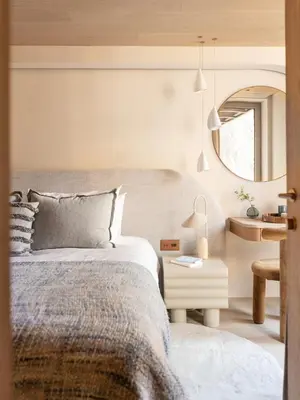 a bedroom with a bed and a table and a mirror at Chalet Acorn in Chamonix-Mont-Blanc