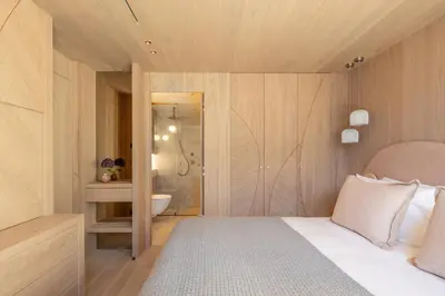 a bedroom with a bed and a bathroom with a shower at Chalet Acorn in Chamonix-Mont-Blanc