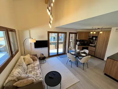 a living room with a couch and a table at Duplex élégant au centre, vue vallée, confort moderne - FR-1-624-185 in Samoëns