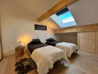 two beds in a room with a skylight at Duplex élégant au centre, vue vallée, confort moderne - FR-1-624-185 in Samoëns