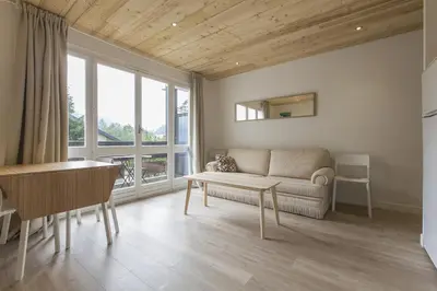 a living room with a couch and a table at Résidence Les Periades - Chamonix in Chamonix-Mont-Blanc