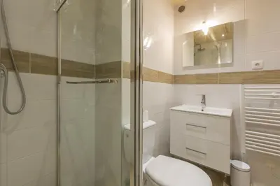 a bathroom with a shower and a toilet and a sink at Résidence Les Periades - Chamonix in Chamonix-Mont-Blanc