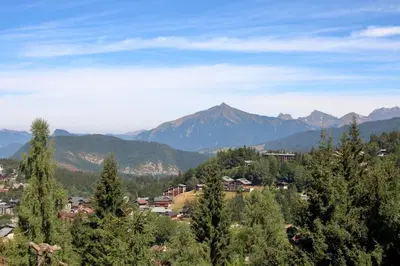 a town in a valley with mountains in the background at BA332 Appartement 4 6 Pers Pied de pistes Carroz in Les Carroz d'Araches