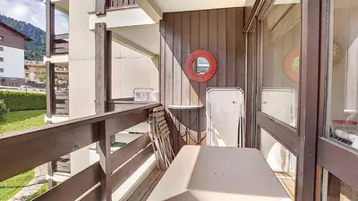 a balcony with a table and chairs on it at 1 RR6169 - Rochebrune- proche pistes in Megève