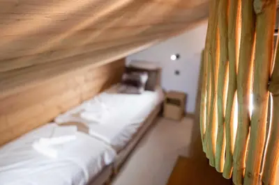 a room with a couch with a phone on it at Cozy Chalet 3BR 6P with Balcony – Megève in Megève