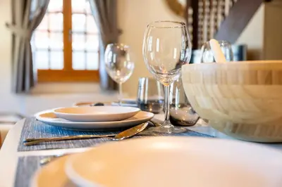 a table with plates and wine glasses on it at Cozy Chalet 3BR 6P with Balcony – Megève in Megève