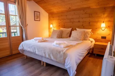 a bedroom with a bed with two towels on it at Cozy Chalet 3BR 6P with Balcony – Megève in Megève