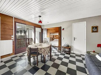 a living room with a table and a couch at MAR219 - Appartement 4 5 pers centre village in Les Carroz d'Araches