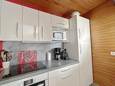 a kitchen with white cabinets and a microwave at MAR219 - Appartement 4 5 pers centre village in Les Carroz d'Araches