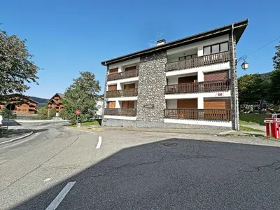 an empty street in front of a apartment building at MAR219 - Appartement 4 5 pers centre village in Les Carroz d'Araches