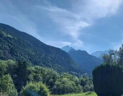 a view of a valley with mountains and trees at La Ferme De Réjane in Saint-Gervais-les-Bains