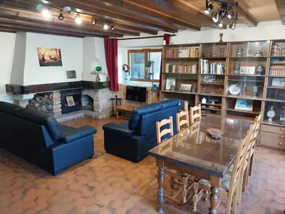 a living room with a table and chairs and a fireplace at La Ferme De Réjane in Saint-Gervais-les-Bains
